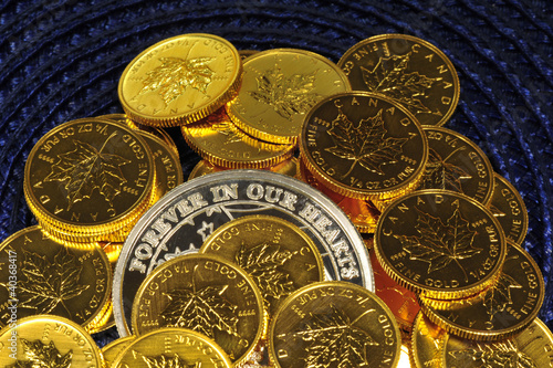 Photo: Gold and silver coins on a blue background Gold and silver coins on a blue background