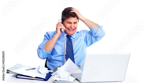 Foto: Busy businessman with laptop computer. Busy businessman with laptop computer.