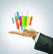 Different laboratory glassware on businessman hand
