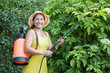 Photo en ligne au meilleur prix Mature woman spraying  plant