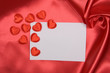 White card on red silk White card on red silk