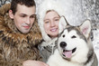 Young couple with a malamute dog Young couple with a malamute dog