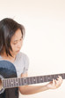 Woman playing classic acoustic guitar.