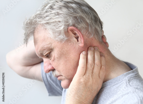 Photo: senior man with sore neck senior man with sore neck