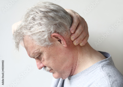 Photo: man with headache at base of skull man with headache at base of skull