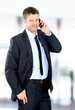 Smiling man using an office phone Smiling man using an office phone
