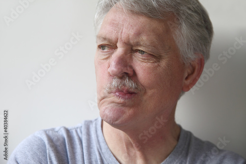 Photo: senior man distorts his mouth senior man distorts his mouth