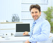Business man sitting at his desk in the office with a