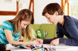 Photo: boy and girl talking about their homework boy and girl talking about their homework