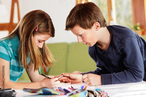 Photo: boy and girl talking about their homework boy and girl talking about their homework