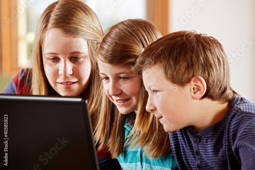 Photo: 2 girls and a boy at the laptop 2 girls and a boy at the laptop