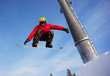 Snowboarder jumping through air with  blue sky in background