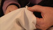 Woman sews a button 1