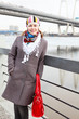 Portrait of happy young female with red bag on embankment Portrait of happy young female with red bag on embankment
