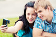 Happy teenage couple taking picture