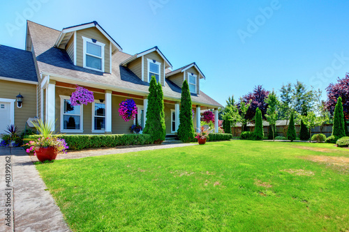 Photo: American Country farm luxury house with porch. American Country farm luxury house with porch.
