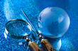 Travelling, magnifying glass and globe