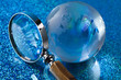 Travelling, magnifying glass and globe