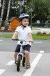 Baby boy on traffic playground for childs with crash helmet