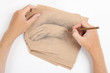 man hand draw picture with palm on brown paper