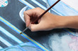 man hand painting blue abstract picture