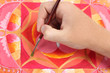close up of man hand painting abstract red picture with circle p