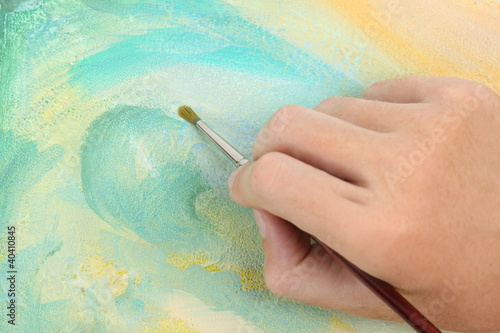 Photo: man hand painting multicolored abstract picture man hand painting multicolored abstract picture