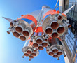 Photo: Details of space rocket engine over blue sky background Details of space rocket engine over blue sky background
