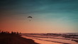 Paraglider and sunset on the beach