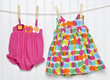 Baby Dress and Bathing Suit on a Clothesline Baby Dress and Bathing Suit on a Clothesline