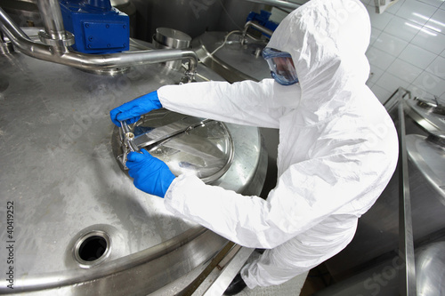 Photo: technician opening industrial process tank technician opening industrial process tank