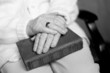 the elderly woman's hands on the book