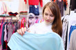 Young woman inside a store buying clothes