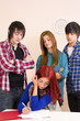 Three of her fellow students behaving in a hostile way Three of her fellow students behaving in a hostile way