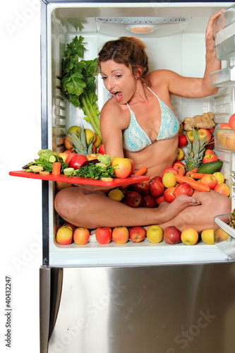Photo: Woman sitting in a fridge Woman sitting in a fridge