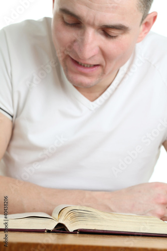 Photo: Man reading the Bible. Focus on the Bible Man reading the Bible. Focus on the Bible