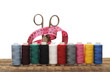 Colorful threads and old scissors on the old wooden table