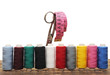 Colorful threads and old scissors on the old wooden table