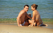Young caucasian couple at the beach
