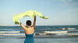 Видео: Woman with waving sarong standing on the beach, slow motion Woman with waving sarong standing on the beach, slow motion
