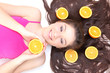 Happy girl with close eyes lying with pieces of orange Happy girl with close eyes lying with pieces of orange