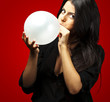 woman blowing balloon woman blowing balloon