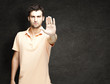 young man doing a stop gesture