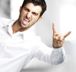 portrait of young man doing rock symbol indoor portrait of young man doing rock symbol indoor