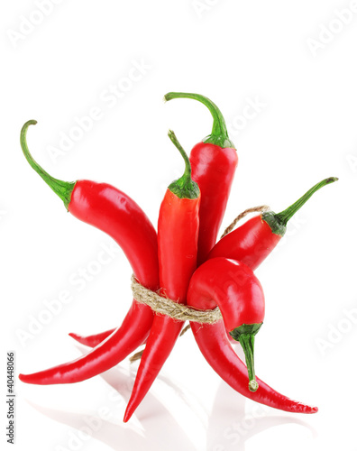 Photo: Red hot chili peppers tied with rope isolated on white Red hot chili peppers tied with rope isolated on white