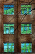 Reflection of Colourful Building in Windows of Old Block