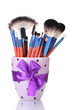make-up brushes in cup isolated on white