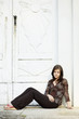 Young Woman sitting, thoughtful and looking away