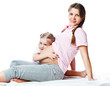 Beautiful pregnant woman with her daughter. Isolated on white Beautiful pregnant woman with her daughter. Isolated on white