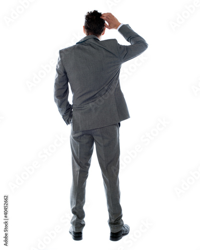 Photo: Back-pose of a corporate person thinking Back-pose of a corporate person thinking